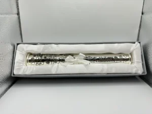 Elegant silver-plated certificate holder for a First Holy Communion, featuring intricate engravings and a secure twist-open design, ideal for preserving a special religious keepsake.