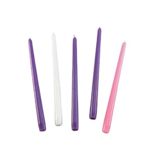 A set of four liturgical taper candles in purple, rose, and white for traditional Advent calendar celebration and Christmas preparation.