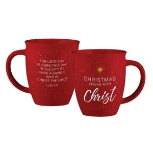 A festive ceramic mug featuring Christmas Begins with Christ text and traditional holiday colors, perfect for thoughtful Christmas gifts.