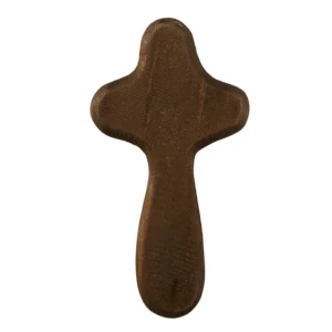 A smooth, dark-toned hand-held prayer cross held in a palm, perfect for spiritual comfort and quiet reflection as part of our Christian gifts collection.