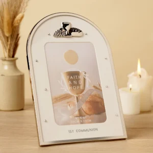 An elegant arched Faith & Hope 4x6 inch photo frame in soft neutral tones, featuring delicate cross and dove embellishments, perfect as a communion keepsake.