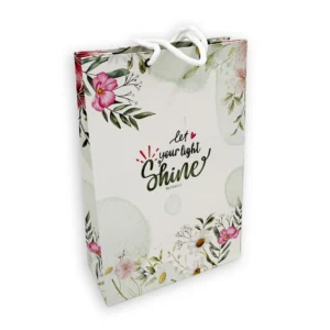 A medium-sized gift bag from our collection of tote bags and pouches, decorated with the encouraging Bible verse Matthew 5:16, Let Your Light Shine, set against an elegant background.