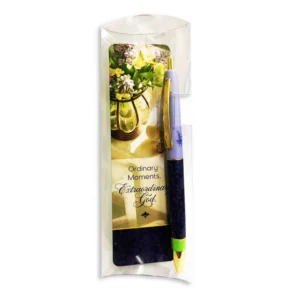 A black ink ballpoint pen paired with a devotional bookmark from the Ordinary Moments, Extraordinary God stationery collection, perfect for faith-based gifting and Bible study accessories.