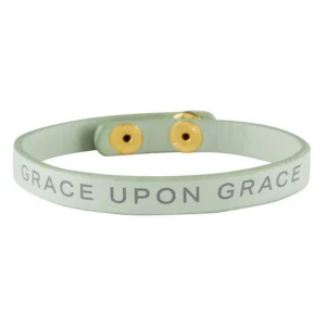 Close-up of a stylish Christian snap bracelet featuring the inspiring phrase 'Grace Upon Grace', a meaningful addition to any collection of faith-inspired wristbands and bracelets.