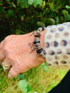 A delicate beaded charm bracelet for women from the Witness Collection, featuring an adjustable fit and customizable silver links for adding personal charms.