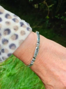 A silver-plated expandable bangle from the Witness Collection for women, featuring detailed religious engravings as a unique piece of faith-based jewellery.
