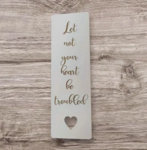 A high-quality bookmark featuring the inspirational quote Let not your heart be troubled, perfect for readers and supporters of the Rock Foundation charity collection of stationery, pens, and bookmarks.