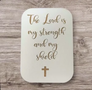 Decorative fridge magnet featuring the inspirational Bible verse The Lord is my strength and my shield, perfect for adding a meaningful touch to any magnetic kitchen surface.