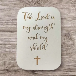 Decorative fridge magnet featuring the inspirational Bible verse The Lord is my strength and my shield, perfect for adding a meaningful touch to any magnetic kitchen surface.