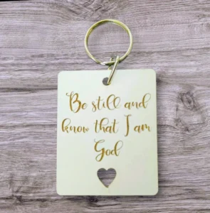 A high-quality metal keyring featuring the inspirational quote Be still and know that I am God, designed as a meaningful gift from the Rock Foundation collection.