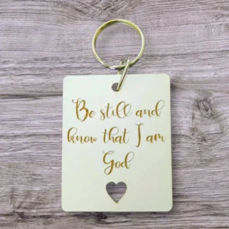 A high-quality metal keyring featuring the inspirational quote Be still and know that I am God, designed as a meaningful gift from the Rock Foundation collection.