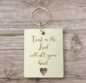 A decorative metal keyring engraved with the inspirational quote Trust in the lord with all your heart, perfect for religious gift-giving or daily use as a meaningful spiritual accessory.