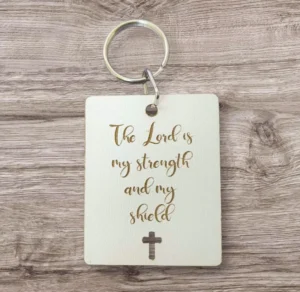 A metal keyring featuring the inspirational quote The Lord is my strength and my shield, perfect for religious gifts and key accessories.