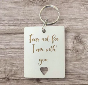 A close-up of a metal keyring featuring the inspirational quote Fear not for I am with you, designed as a meaningful gift from the Rock Foundation charity collection.