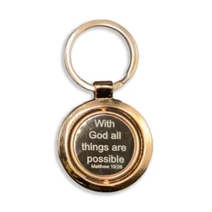 A close-up shot of a polished copper keyring engraved with the inspirational quote With God all things are possible, displayed as a meaningful accessory within our collection of faith-based keyrings.