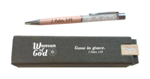 An elegant soft pink executive pen for women featuring engraved faith-inspired details, presented inside a decorative boxed gift set for stationery collectors.