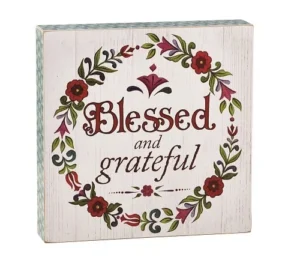 A decorative wooden box-style hanging plaque featuring the text Blessed and Grateful, displayed as faith-inspired wall decor for a home or kitchen.